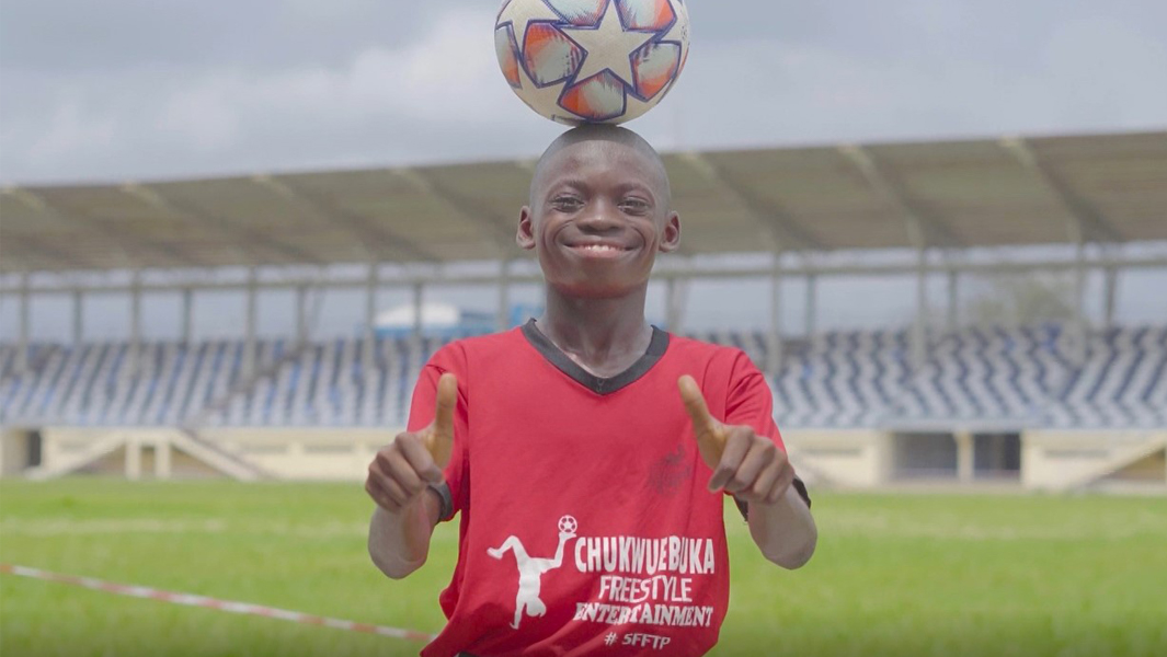 Chinonso Eche smiling and playing in a soccer stadium