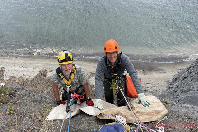 Dr Etches and climbing expert Tim Fogg about to abseil to survey the excavation area