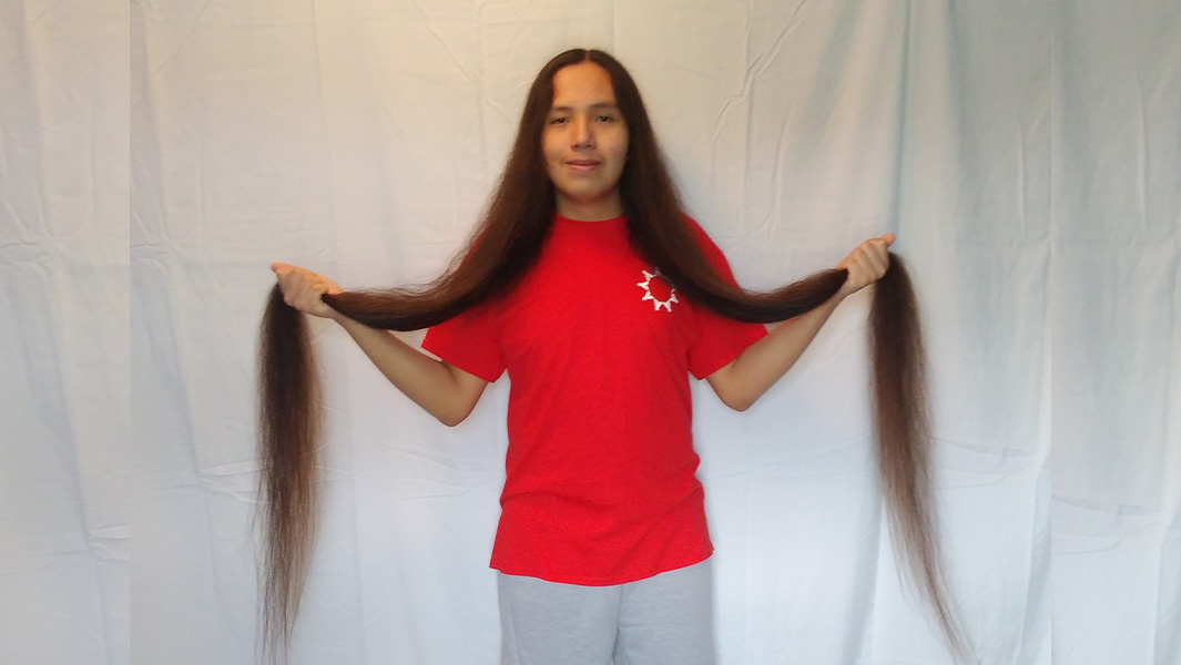 longest hair teen holding his hair
