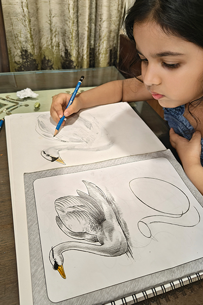 Anvi learning how to draw a swan