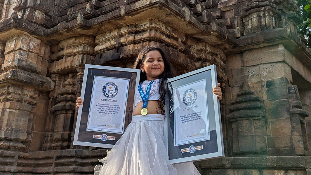 One picture of Anvi Vishesh Agrawal holding her book and one of her holding her two framed GWR certificates