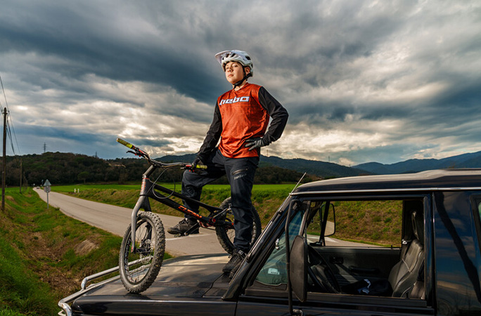 Jordi Sala stood with his bike on a car bonnet
