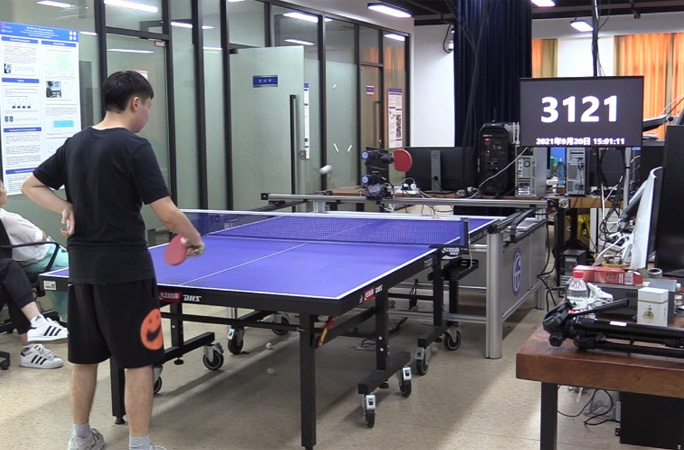Robot playing ping pong with human