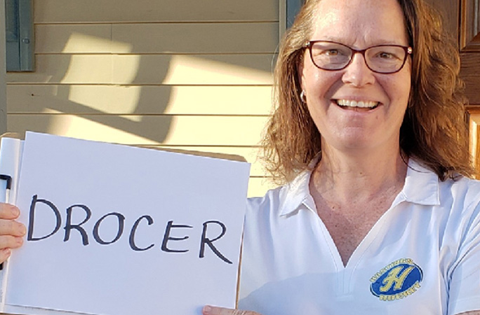 Woman holding record sign spelled backwards