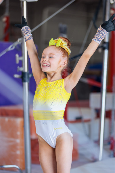 Kynlee posing after landing with arms up