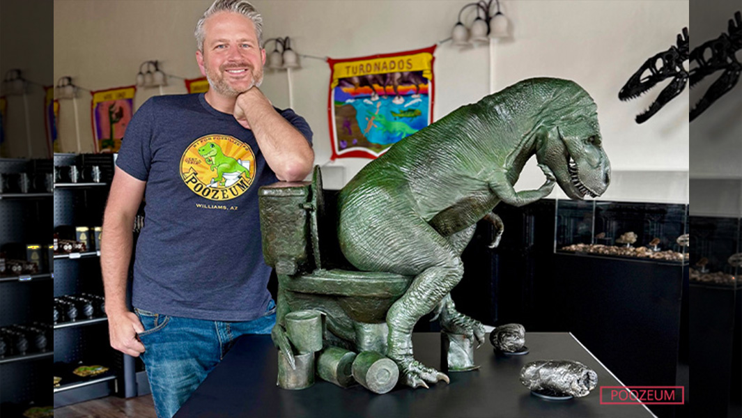 poozeum owner with dinosaur on toilet statue