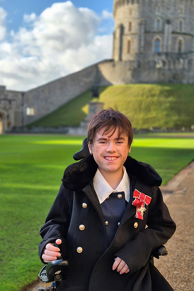Carmela outside Windsor Castle in her wheelchair