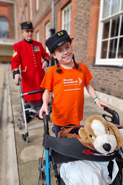 Carmela walking with her walking aid
