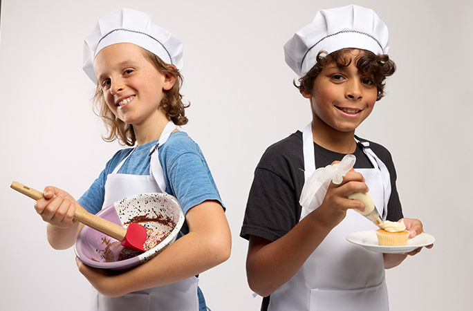 boys baking and decorating cupcake