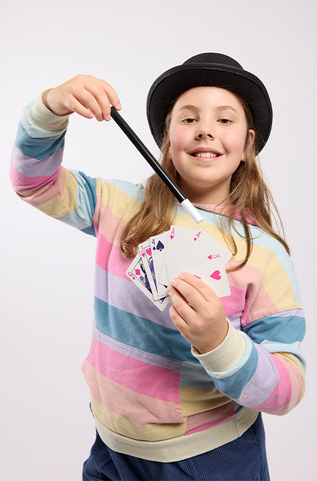 Girl holding magic wand and card deck