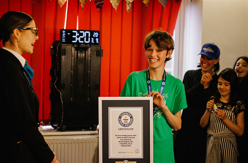 Micah holding record certificate