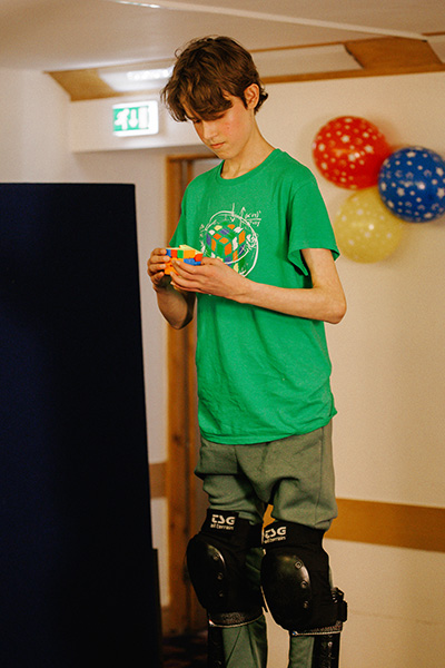 Micah solving cubes on stilts