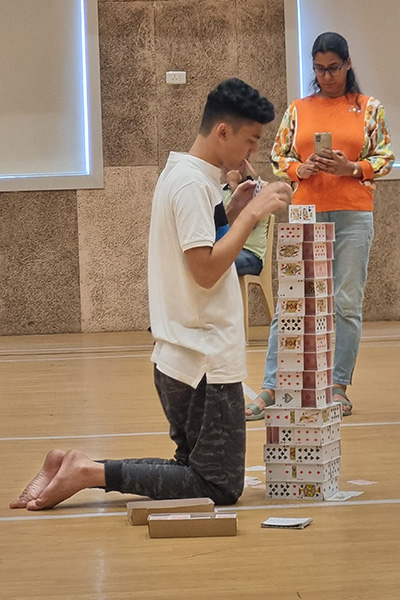 Arnav on his knees building tower