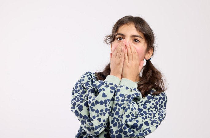 Girl with hands in mouth