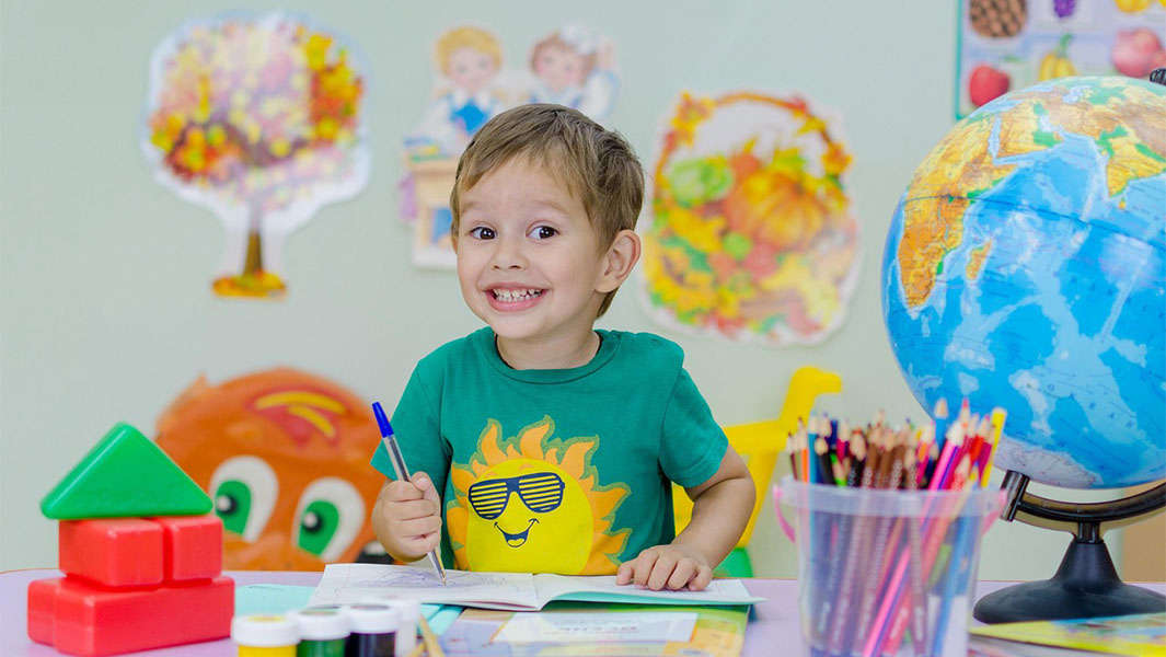Boy writing on desk
