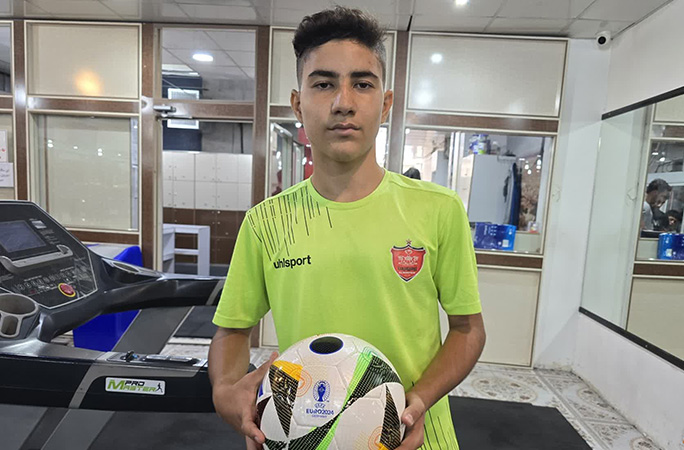 Meraj holding a football