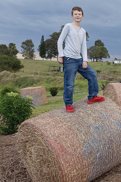 Lachlan stood on a hay bale