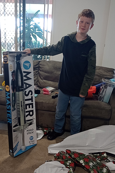 Lachlan stood next to his new pogo stick on Christmas Day 2023