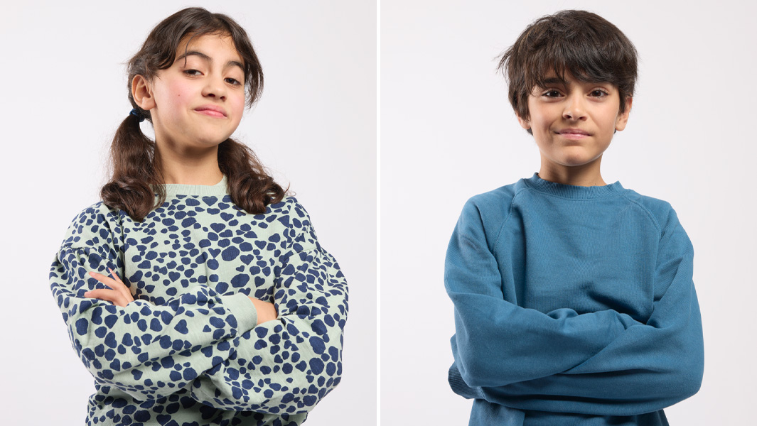 Boy and girl with crossed arms