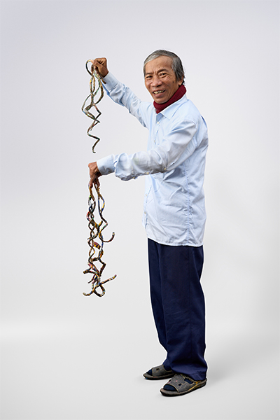 man with longest fingernails posing white background