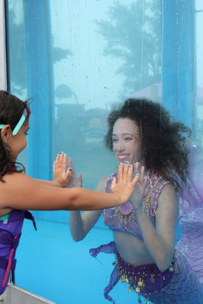 Girl looking at mermaid