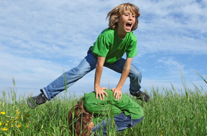 Boys doing leapfrog jumps