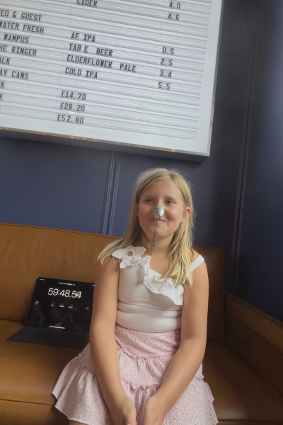 Matilda sitting with spoon on nose