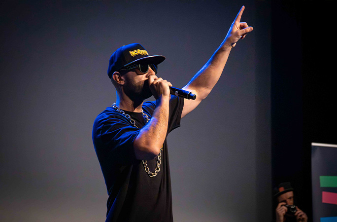 MC Grammar performing hand up