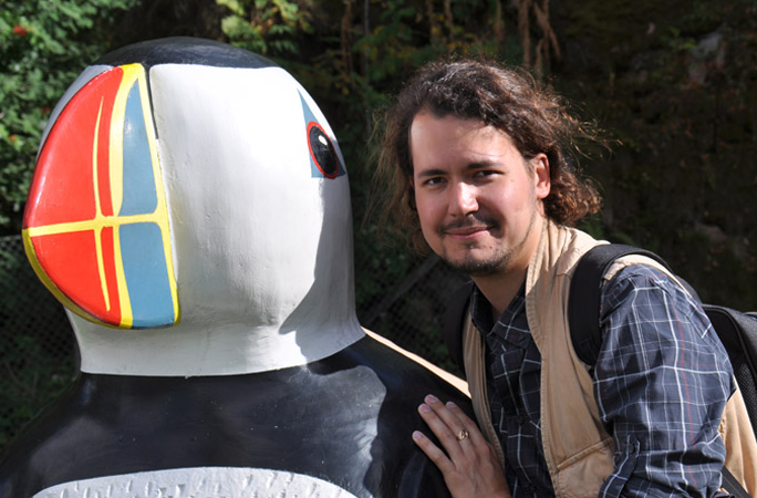 Jonas posing with penguin statue