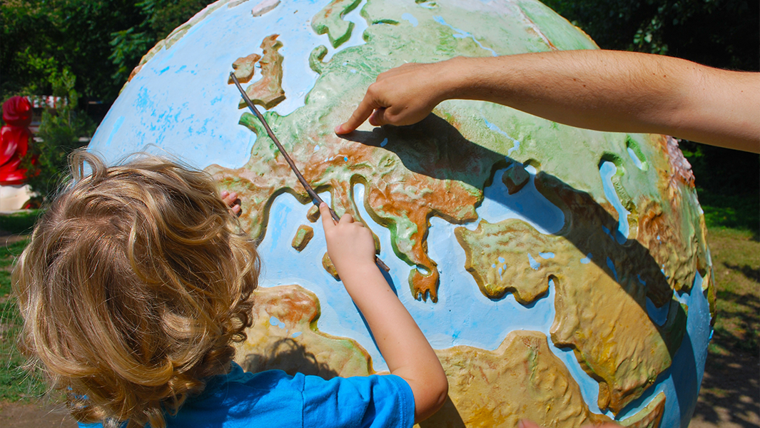 split image Jonathan attempting record kid with globe