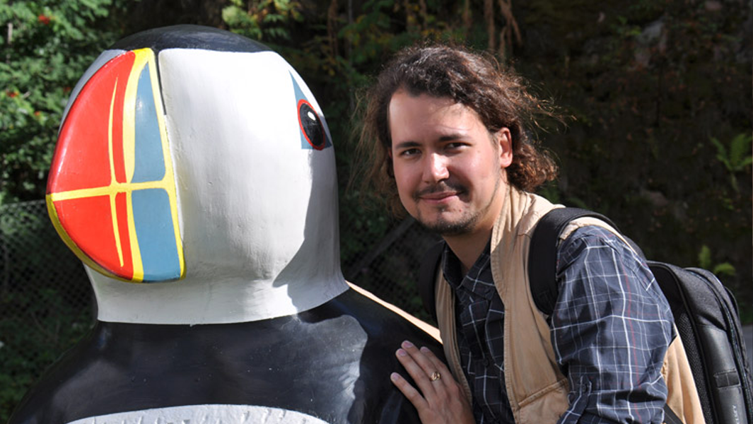 split image Jonas posing with skeleton and penguin