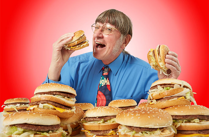 man eating burgers