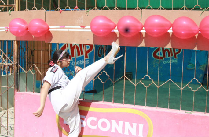 girl kicking balloons