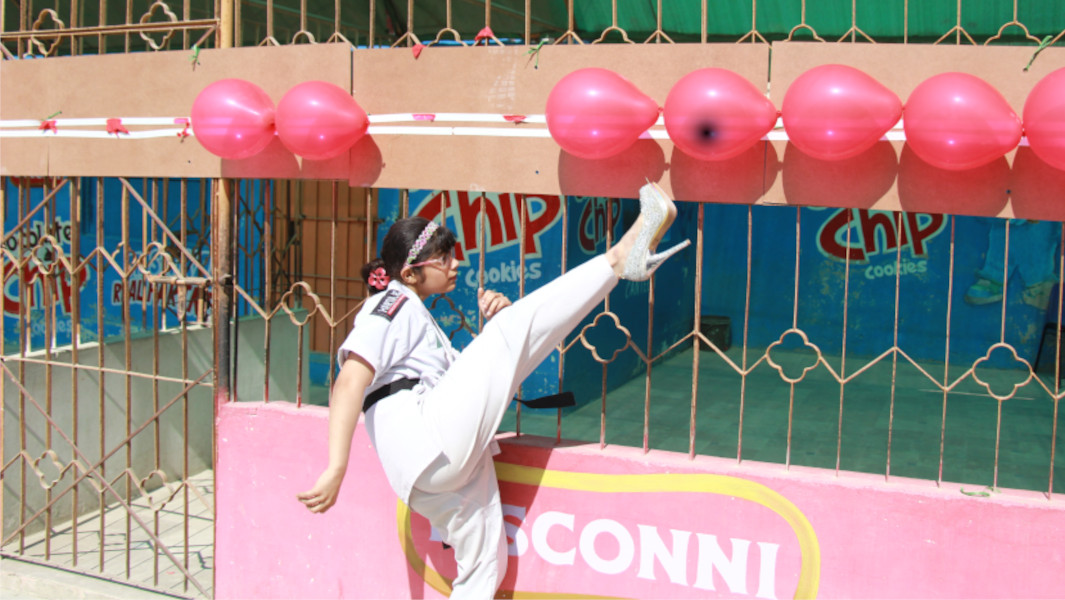 Girl kicking balloons