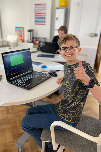 Max smiling with his thumb up at his laptop during his record attempt