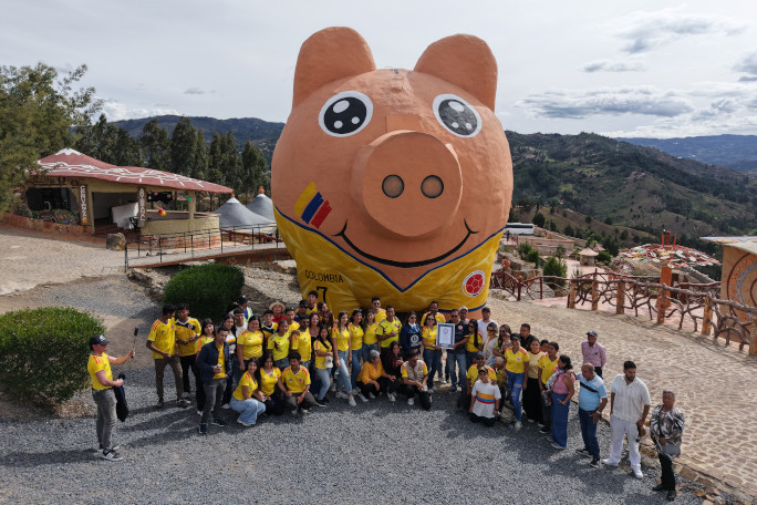 team in front of piggy bank