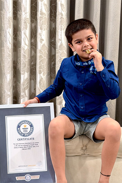 boy biting his medal