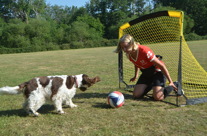 dog with owner at football goal
