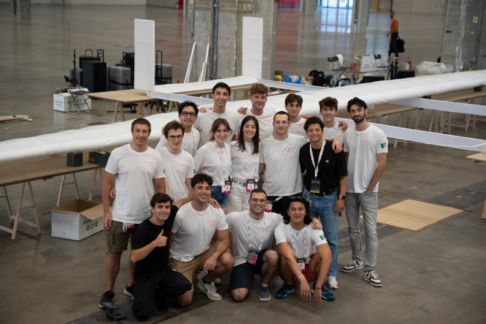 group pic in front of plane