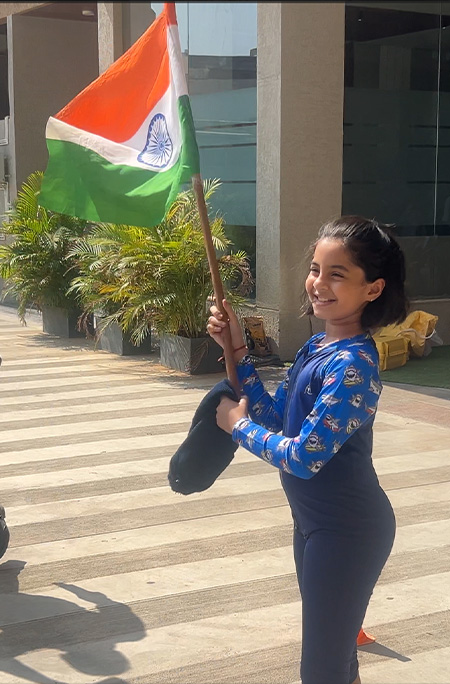 Takshvi holding flag