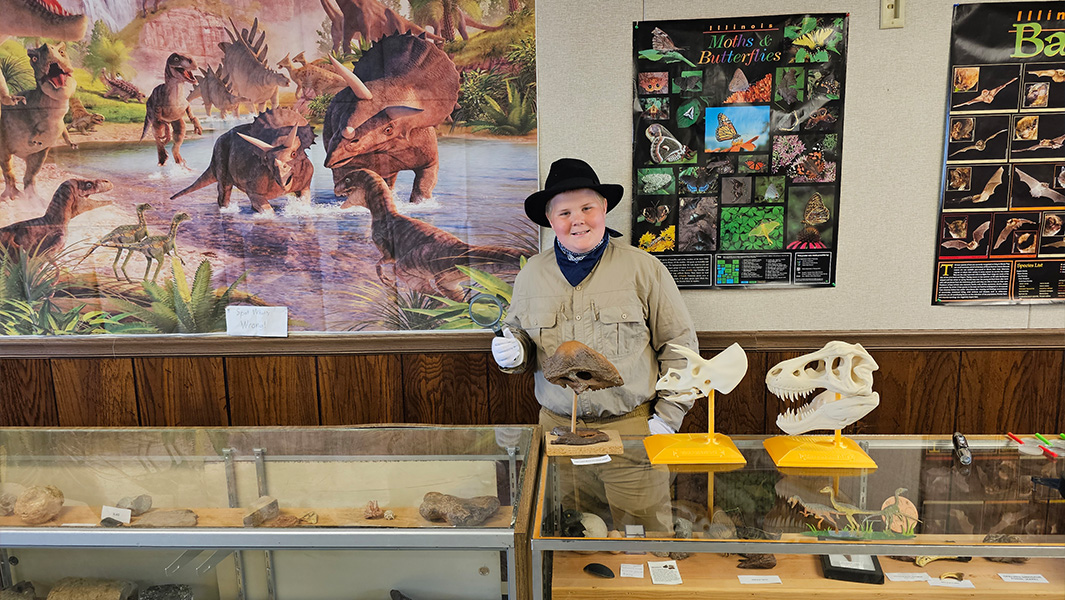 split image Anderson in museum and holding certificate