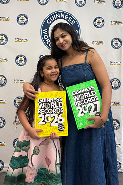 Anvi and her mum stood holding two GWR books