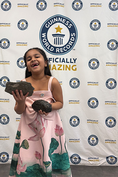 Anvi laughing while holding the oldest vomit and a coprolite