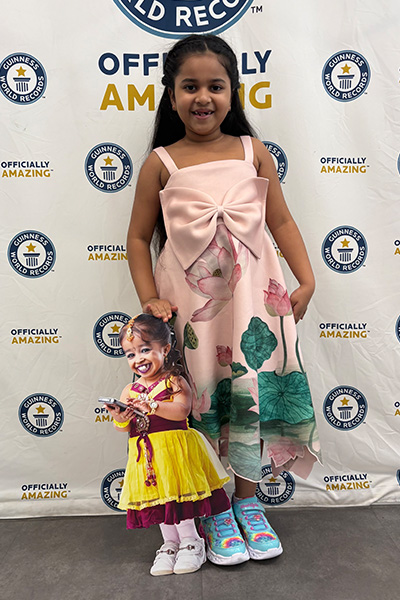 Anvi with the cardboard cutout of Jyoti Amge