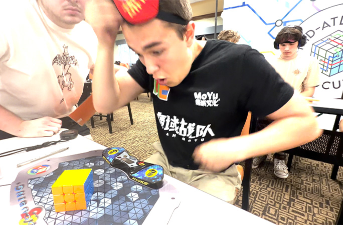 tommy looks at cube amazed