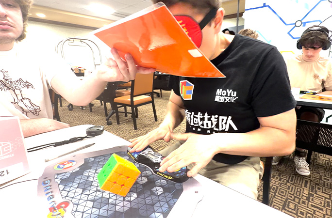 tommy speedcubing blindfolded hands on table
