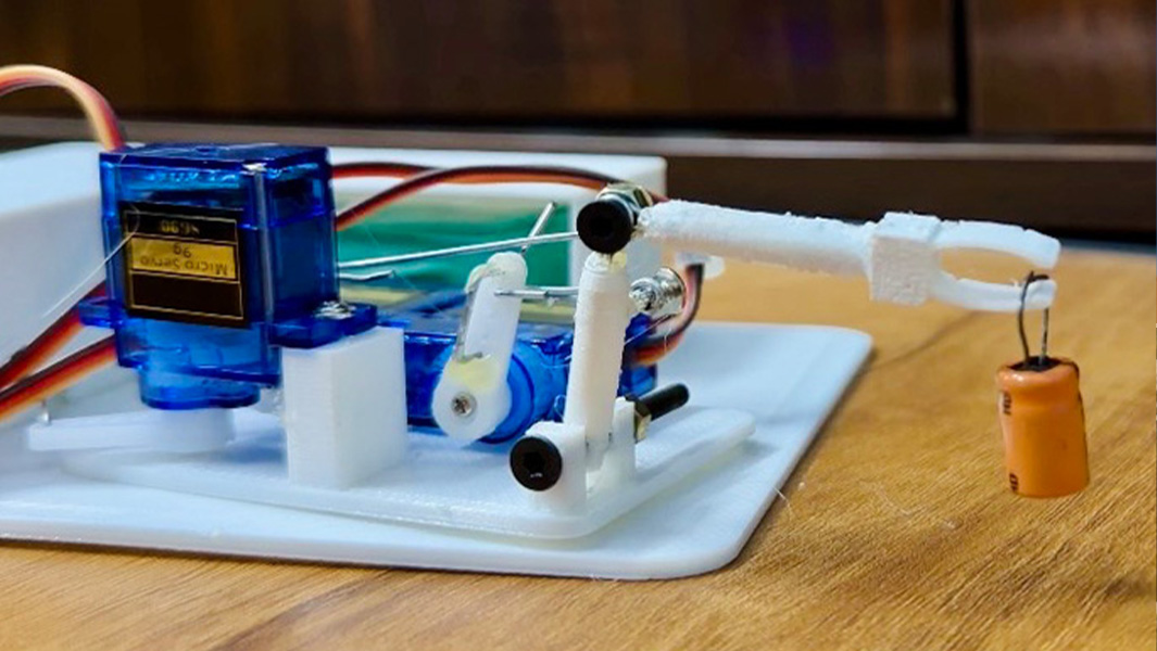 split image smallest robot arm close up hiten with certificate