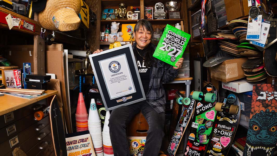 split image judi holding certificate and book