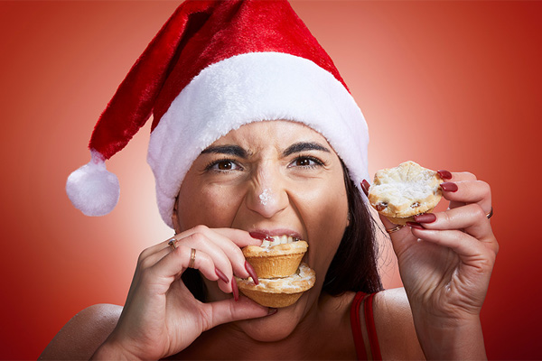 woman eating mince pies