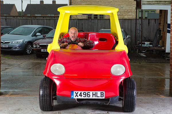 man in largest cozy coupe